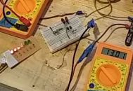 Image: The moment of truth test of the Benitez-7 using a 555 timer. The board didn't smoke, the IC took the two different voltage sources just fine, the battery charging function is ok, but the LED power meter indicates 6.8 - 7V going into the 12V positive rail...