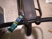 Image: With my cart attached, the bungee hitch allows a little bit of side play, but a little duct tape on the ends of the plastic grip should fix that. The dog collar serves as a safety strap; another would be better...