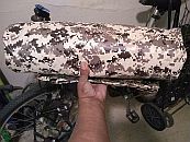 The double camo tarp rolled up tight can fit in the handlebar harness as the sleeping gear goes in a front rack...