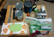 Mock up of the items for the trunk part of the trunk bag - Butter knife; Spork; 1-2 no cook dinner items in cans; Travel Coffee cup w. Lid; Stevia bottle; P-38 Can Opener; Hand Sanitizer; Gatorade water bottle in the rear pocket; kitchen wipes; Snacks for 2 days (6-9 items)...
