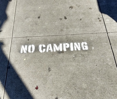 These signs have started showing up on some sidewalks after homeless tents have been cleared from them...