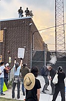The moment Reverend David Black, a regular protester outside of the Broadview Detention Center, was shot in the head with a pepper ball by ICE agents on the roof of the facility 09/19.  Image from video shot by Kelly Hayes ‪@mskellymhayes.bsky.social‬...