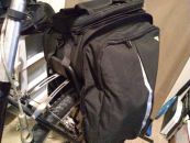 Image: The trunk bag side panels expand into panniers. The velcro straps underneath and in front attaches to the rack, and tie-downs secure the pannier bottoms to the rack frame...