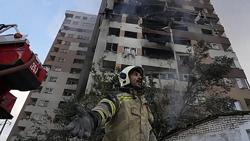 A firefighter stands in front of a building in northern Tehran hit by one of the Israeli attacks on the morning of June 13. Photo: Vahid Salemi/AP...